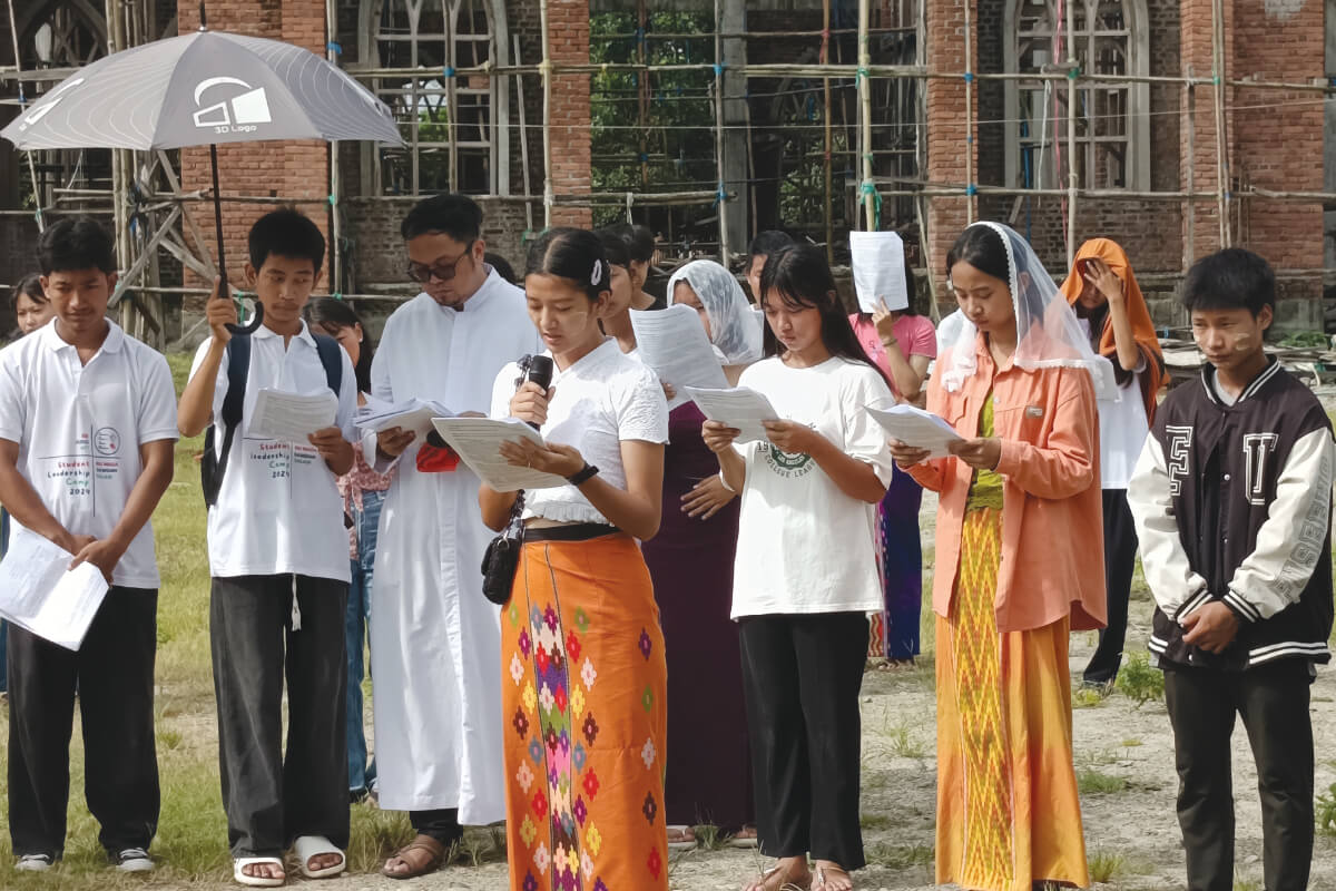 Fr Kurt Zion Pala with young people at a Stations of the Cross prayer in Myanmar