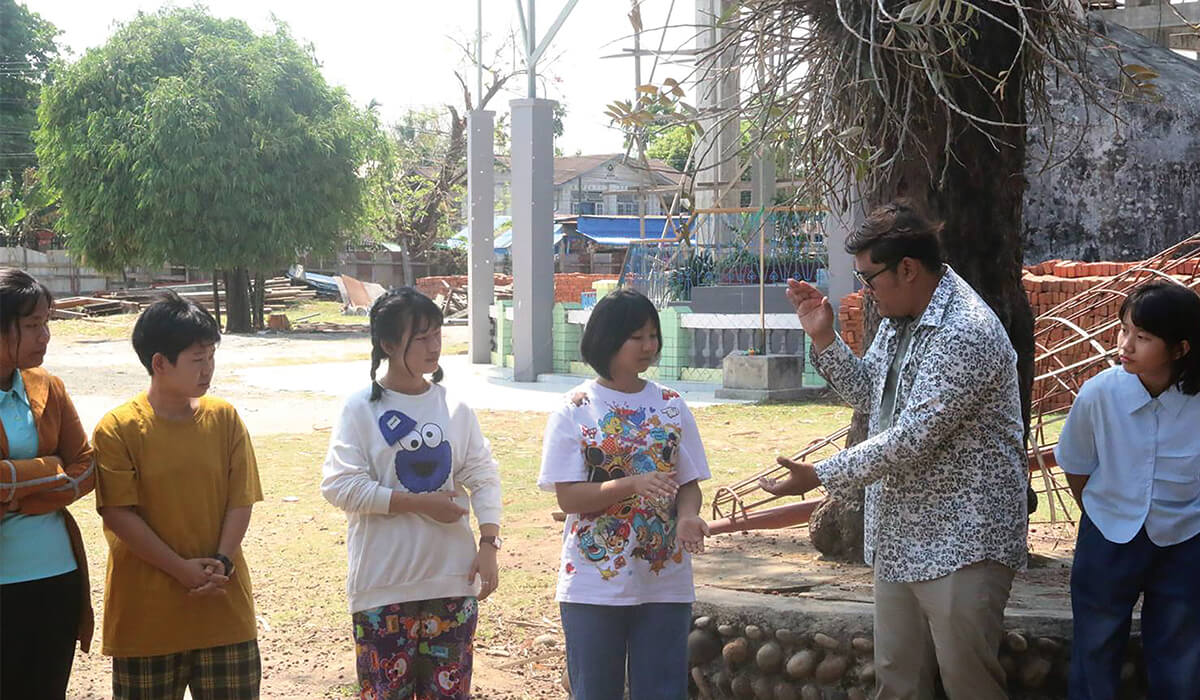 Teacher Zau Seng Awng participating in a group activity with students. - Photo: Fr Kurt Zion Pala SSC