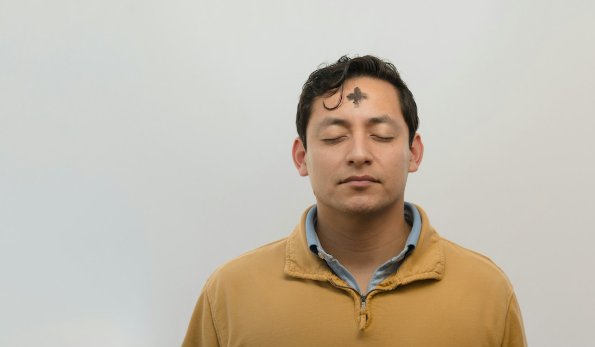 A man with cross on his forehead. Ash Wednesday.
