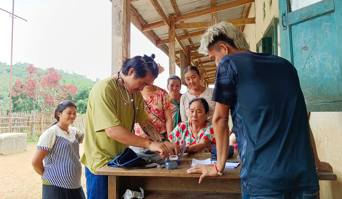 Henry offering medical support in the rural villages of Myanmar. Photo: Michael Javier