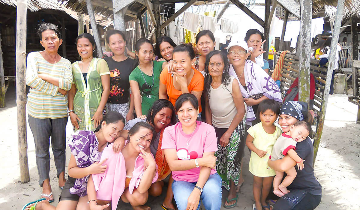 Columban lay missionary Ana Flores (front-center) with women and children in the Narulang community. Photo: Ana Flores