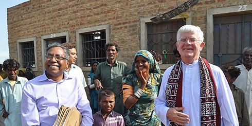(right) Columban missionary priest, Fr Robert McCulloch visiting the housing project for the homeless in Sindh, Pakistan, in 2015.